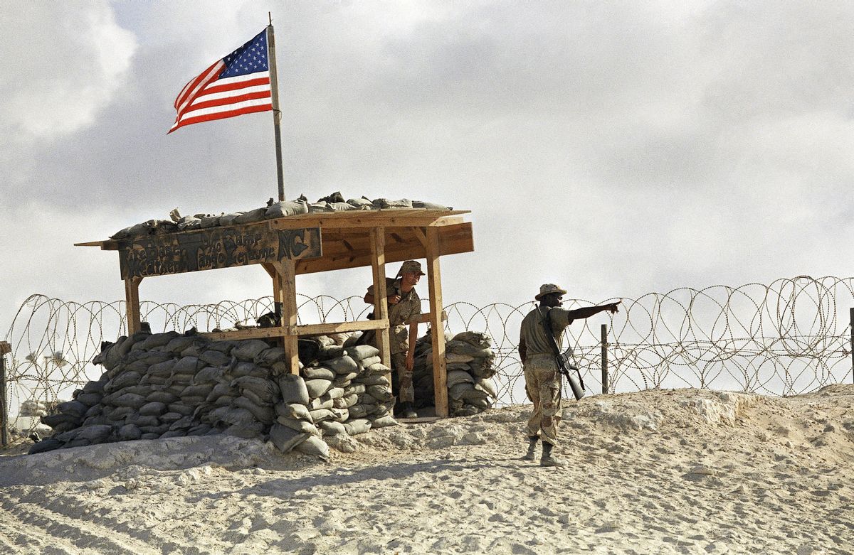 Stf. Sgt. Michael Lewis points out U.S. Navy ships on the Mogadishu coast on Wednesday, March 23, 1994.  (APAP Photo/John Moore)